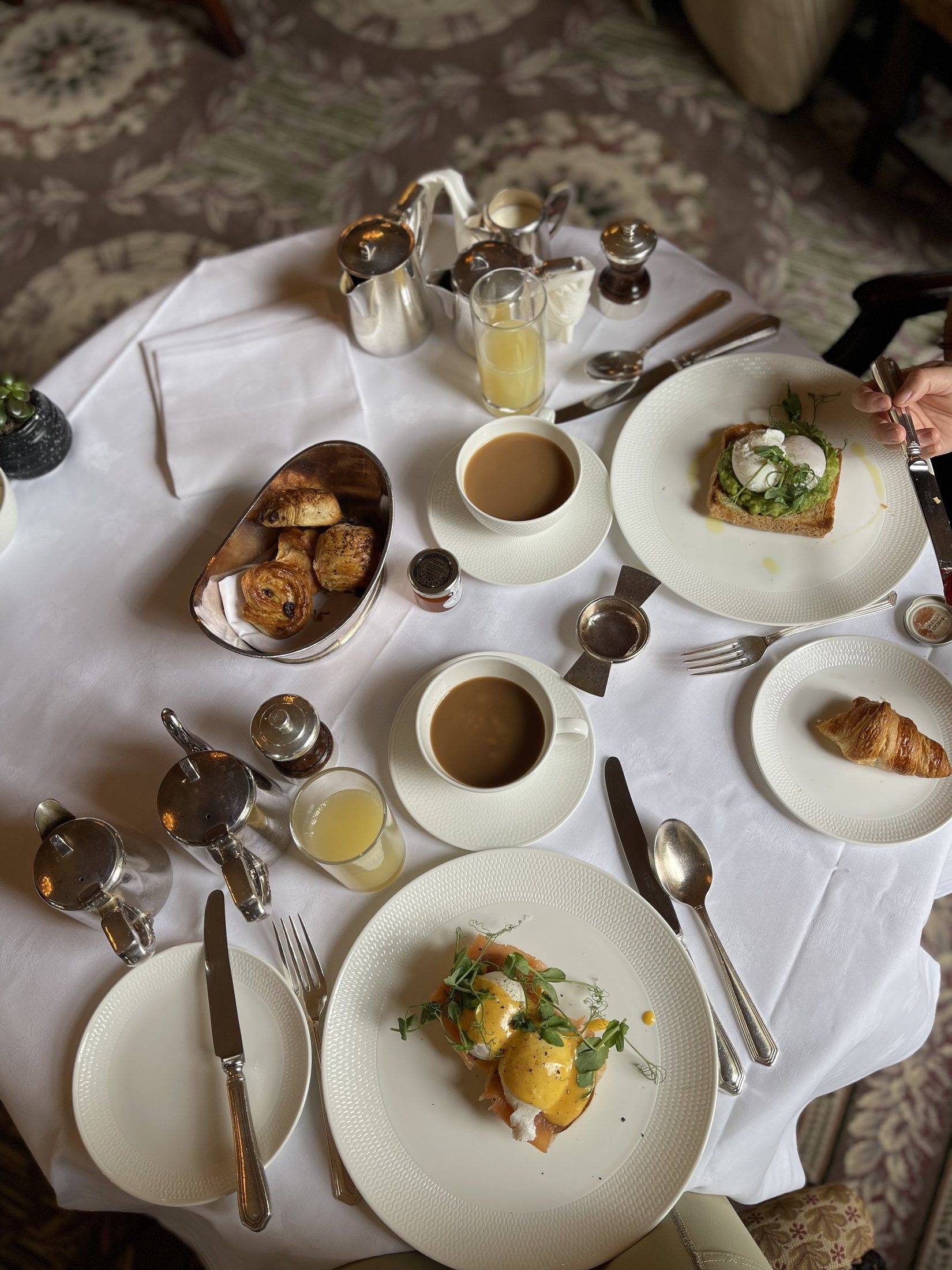Breakfast from above: silver service, pastries, eggs and coffee.